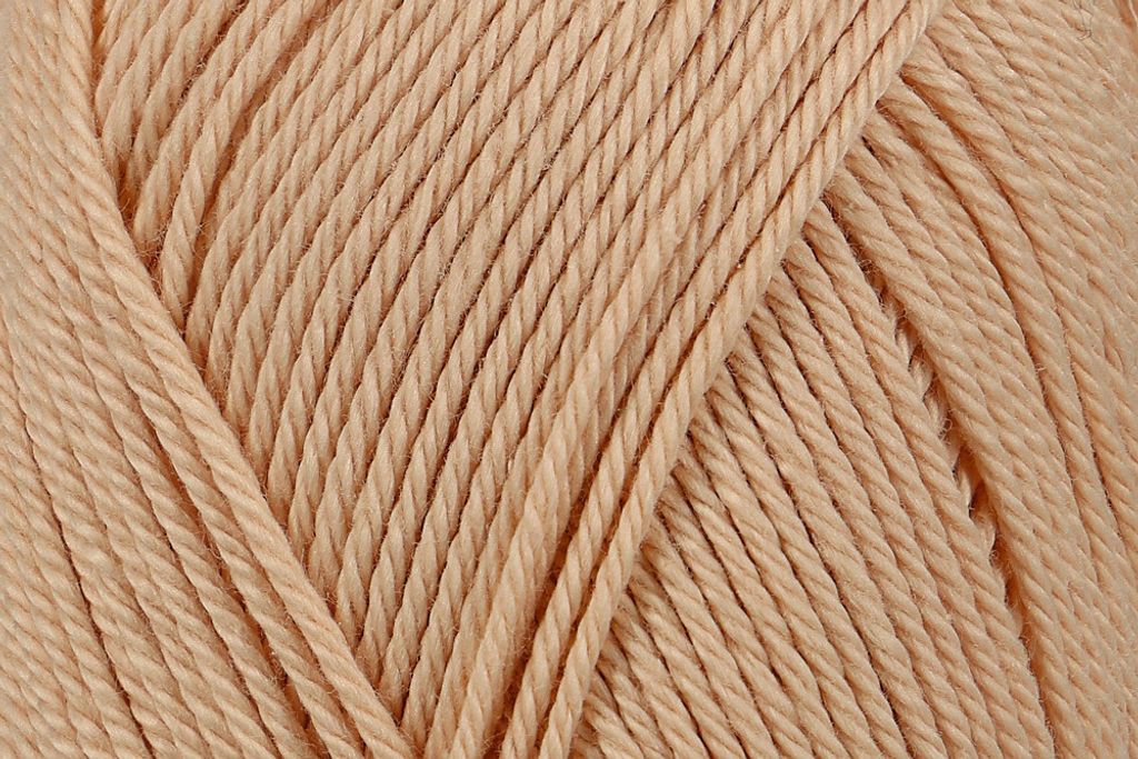A close-up view of beige yarn.