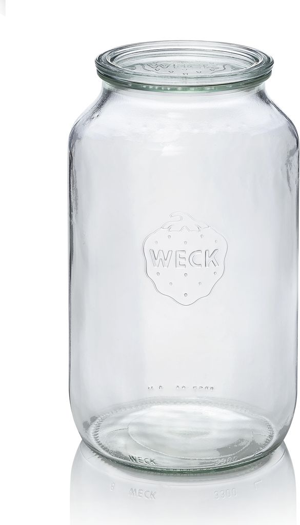 A clear studio shot of an empty glass jar.