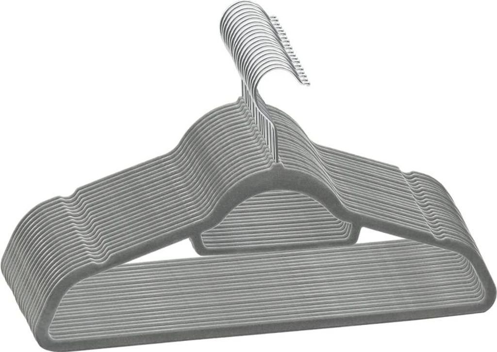 A stack of gray velvet hangers with metal hooks, isolated on a white background.