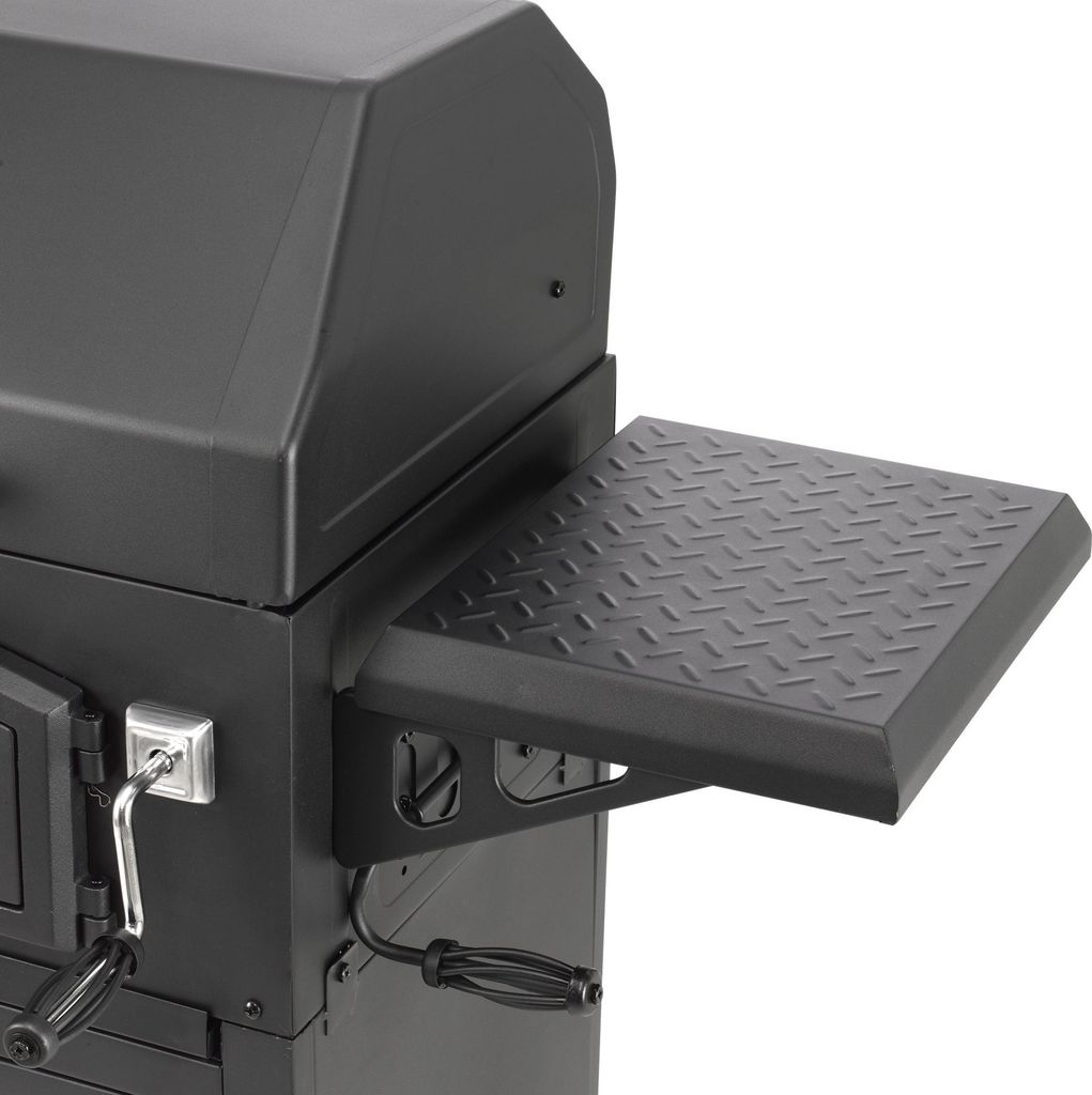 A close-up view of a black charcoal grill, focusing on the side shelf and part of the lid.