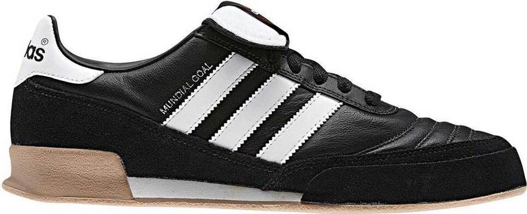 A side view of a black Adidas Mundial Goal soccer shoe.