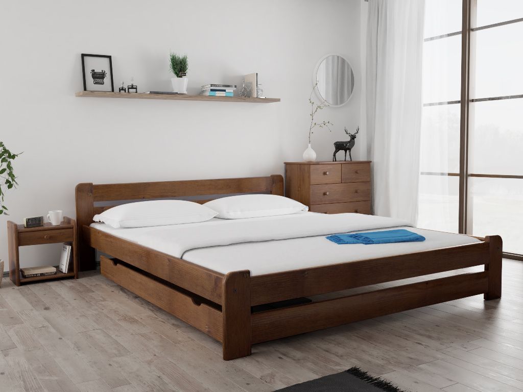 A wooden bed frame with white bedding in a bedroom setting.