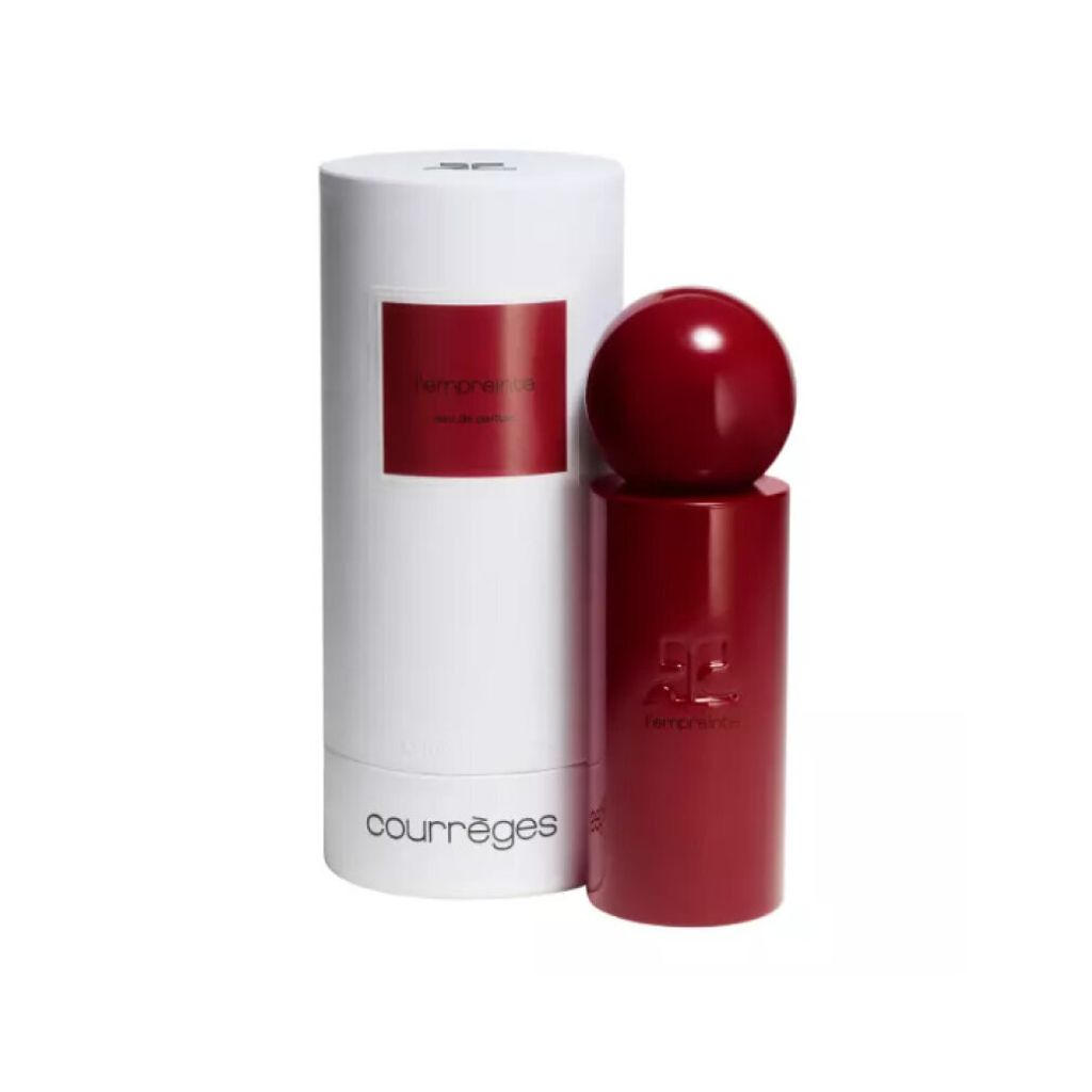 A red perfume bottle with a spherical cap and a white cylindrical box, both featuring branding and text.