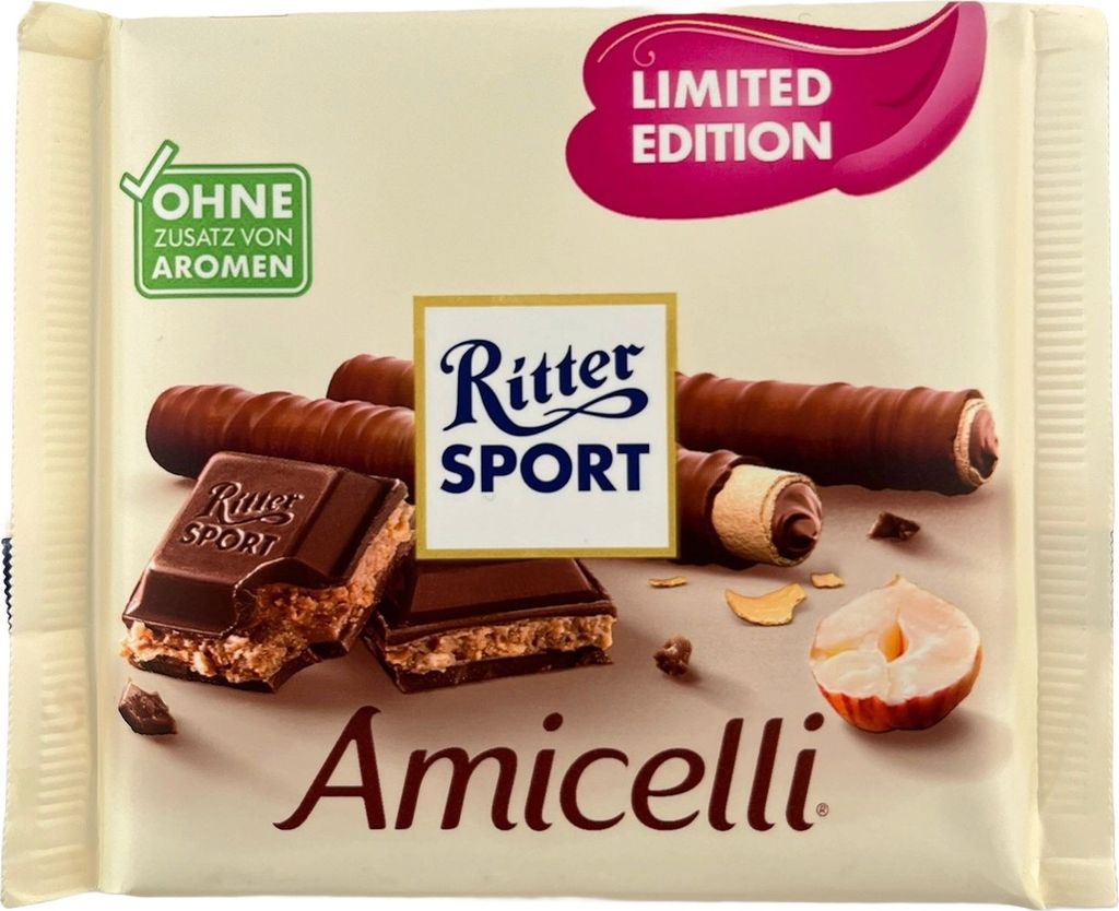 A Ritter Sport Amicelli chocolate bar with a hazelnut cream filling, shown with some of the chocolate broken to reveal the filling, and a halved hazelnut.