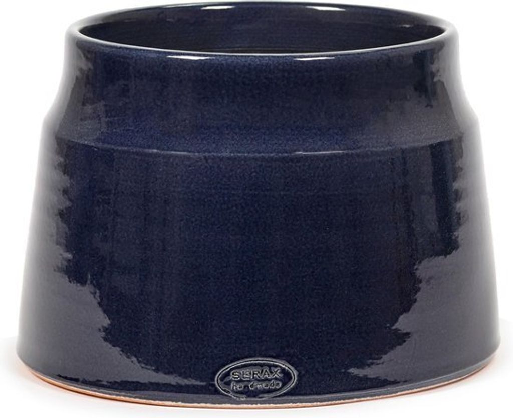 A dark blue ceramic pot with a textured finish sits on a white surface.