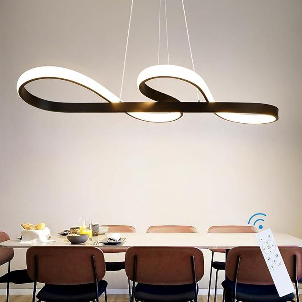 A modern LED pendant light fixture hangs above a dining table set with chairs and place settings.
