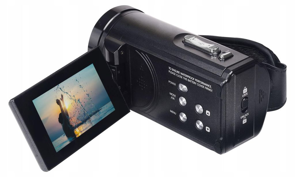A black camcorder with its screen open, showing a silhouette of a person jumping in the water.