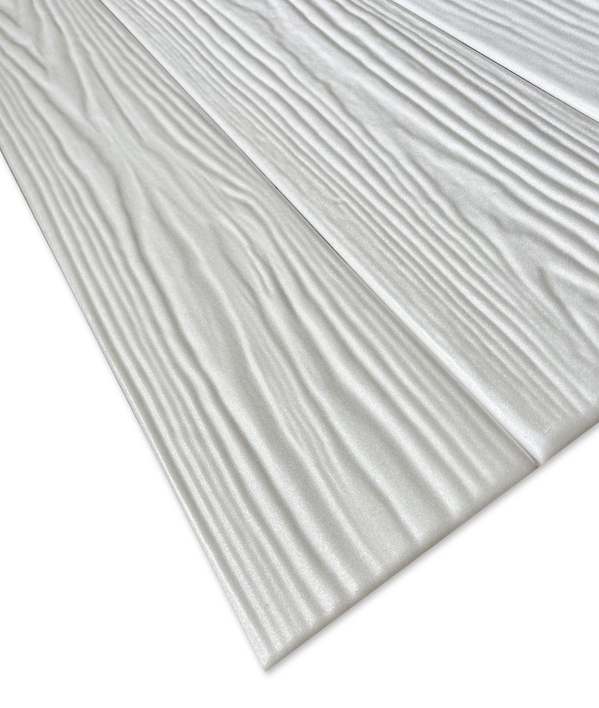 A close-up, angled view of white wood-like panels with a textured grain pattern, laid out diagonally against a white background.
