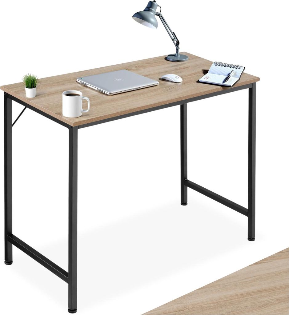 A desk with a laptop, mouse, lamp, and mug.