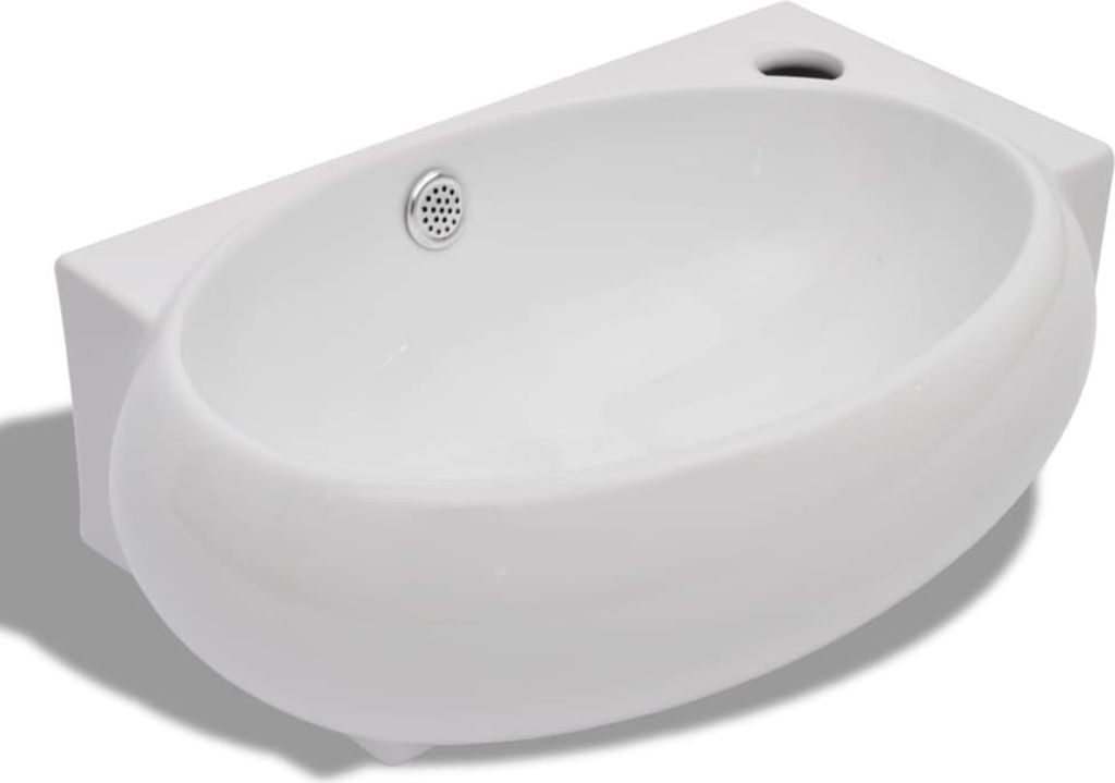 A white ceramic sink with a drain and an overflow hole.
