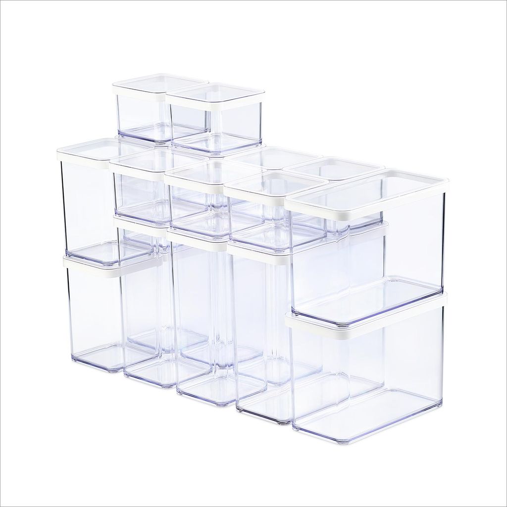 A set of clear plastic food storage containers with white lids, arranged in a stepped formation.