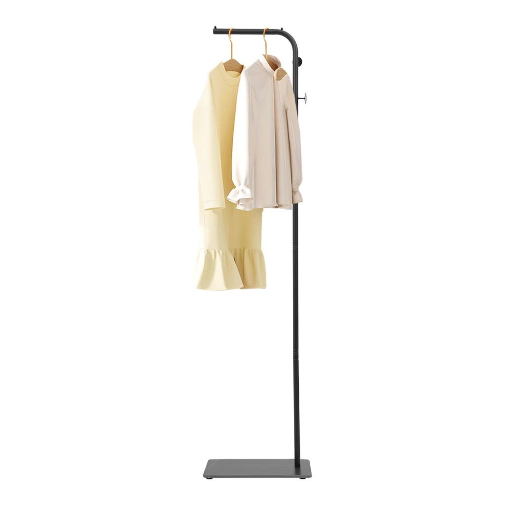A black freestanding coat rack with a slate base, displaying a yellow dress and a cream jacket on hangers.