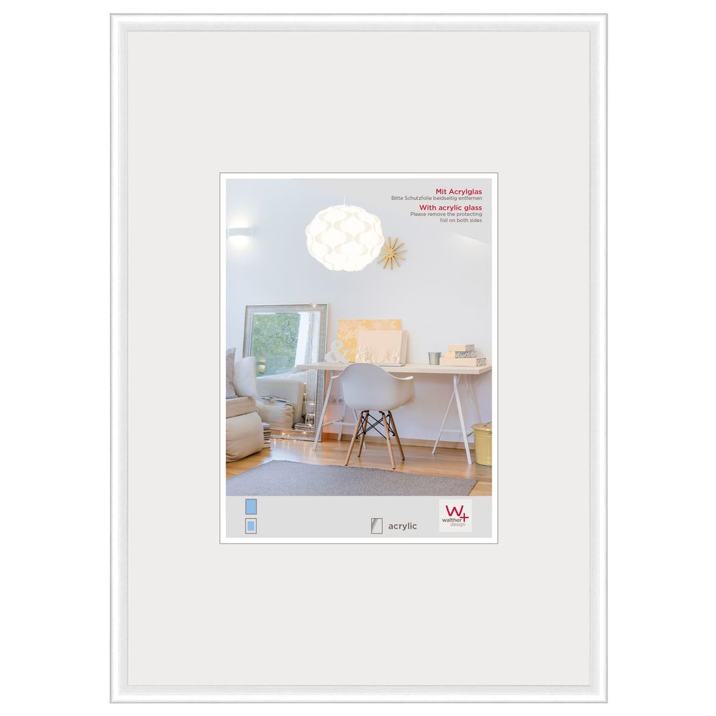 A framed picture of a room with a desk and chair.