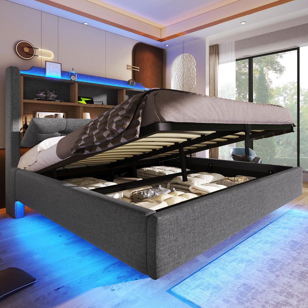 A modern bedroom with a grey upholstered bed frame featuring built-in storage and LED lighting.