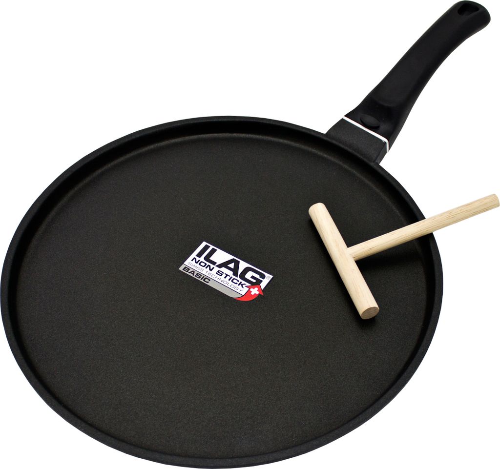 A black crepe pan with a wooden spreader on a white background.