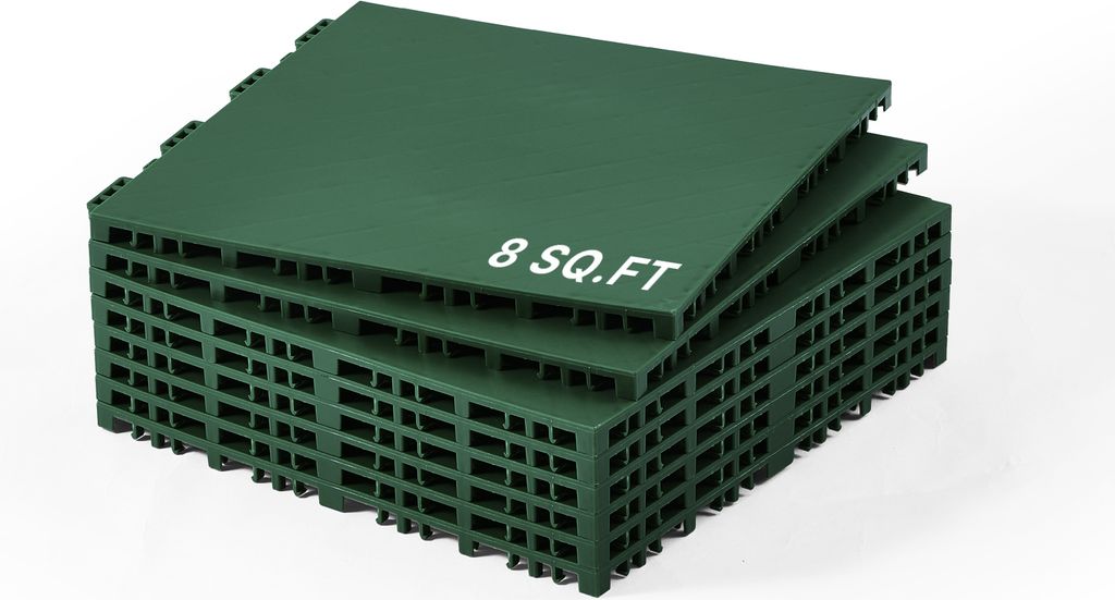 A stack of green interlocking floor tiles.