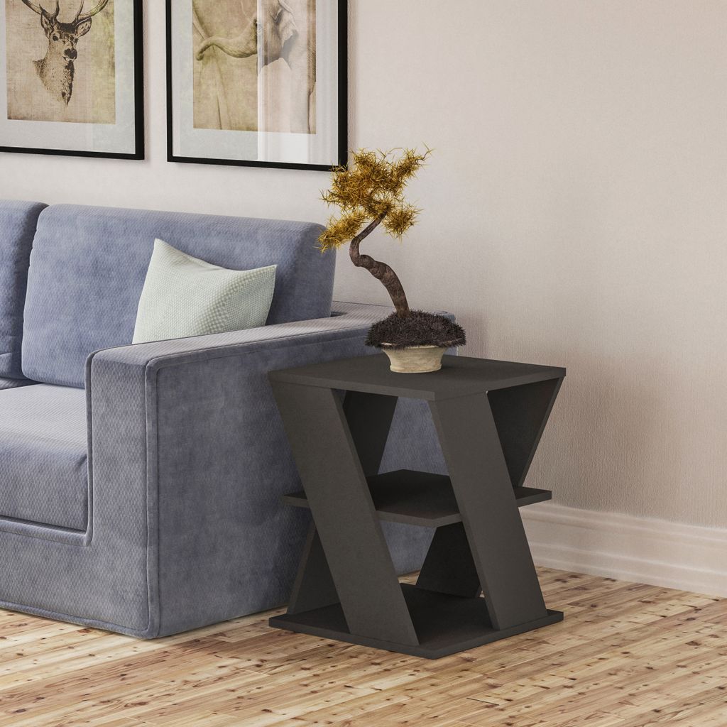 A modern living room scene with a couch, a side table, and artwork on the wall.