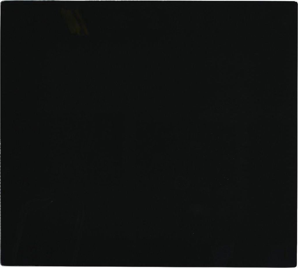 A black glass plate, likely a stove top cover or splashback.