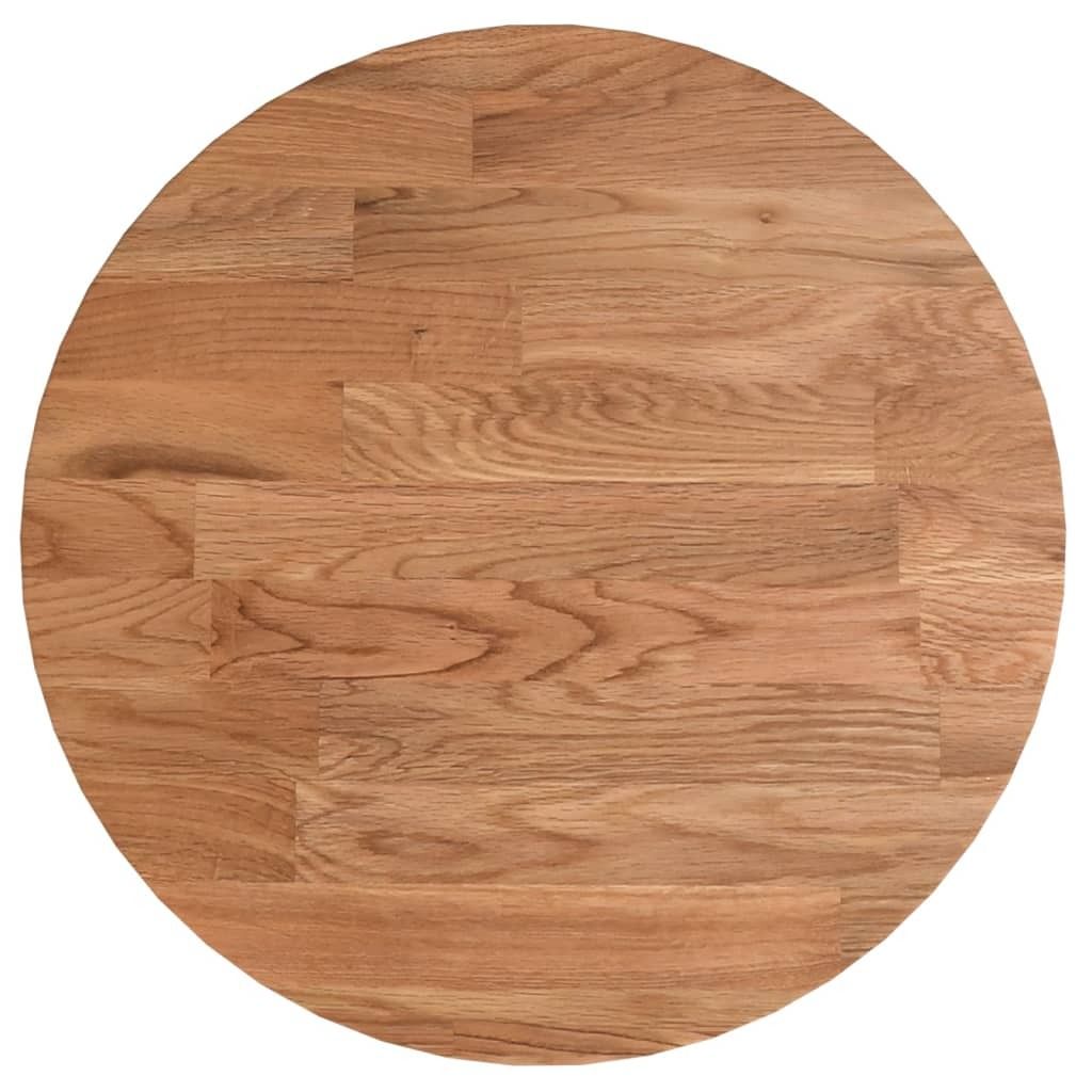 A circular wooden tabletop made of light brown oak wood, showing the grain and wood planks.