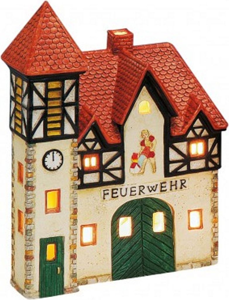 A decorative ceramic fire station building with lights.