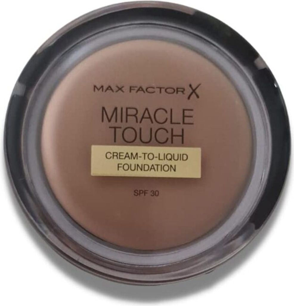 A top-down view of a Max Factor Miracle Touch foundation compact.
