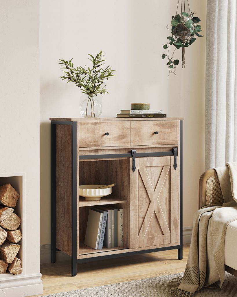 A wooden sideboard with a sliding barn door, placed in a room with a fireplace and a hanging plant.