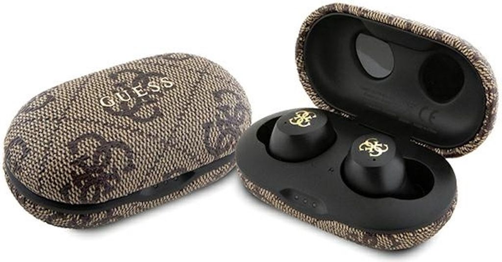 A pair of black wireless earbuds with gold logos, shown inside an open brown charging case with a Guess logo pattern.