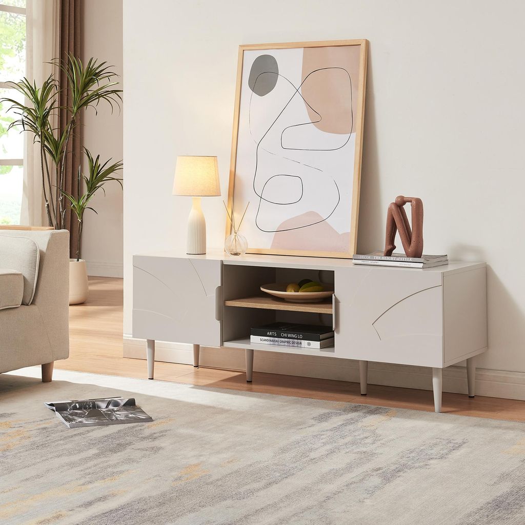 A modern living room scene featuring a beige TV stand with decorative items and artwork.
