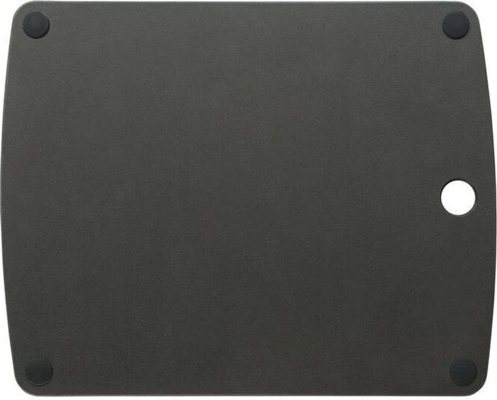 The back of a black cutting board with four rubber feet and a circular cutout.