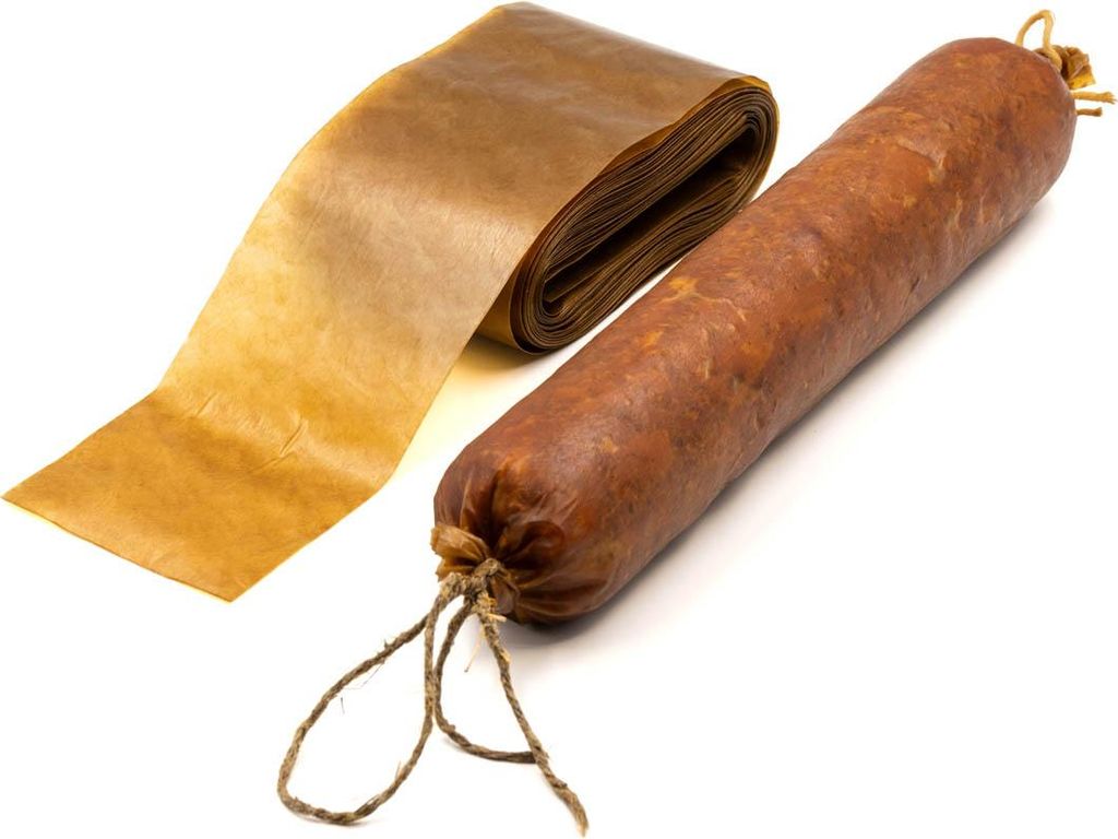 A roll of brown casing material and a sausage are displayed on a white background.