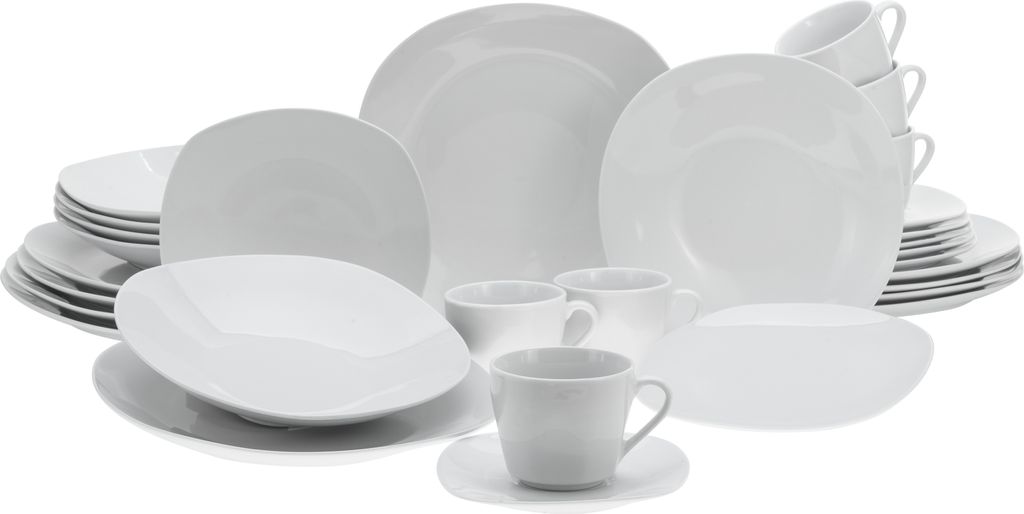 A collection of white ceramic dinnerware, including plates, bowls, and cups, arranged on a white background.