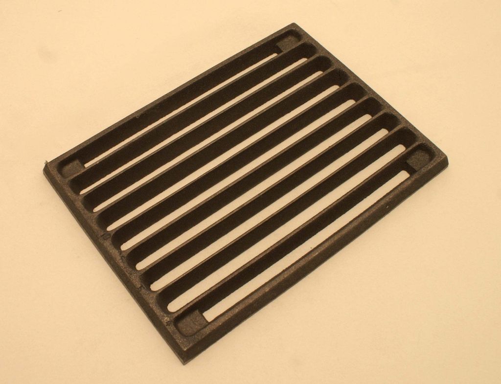 A cast iron grate for a stove or fireplace.
