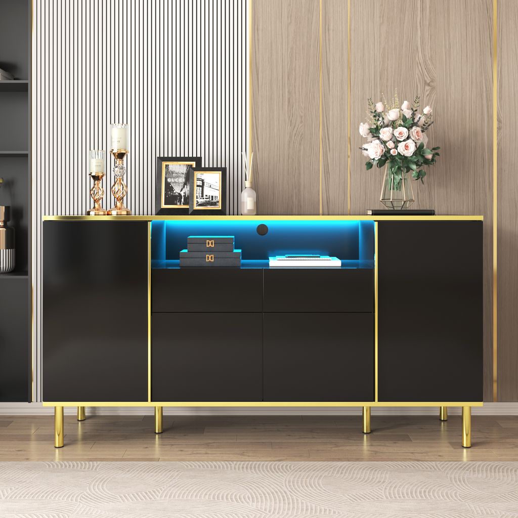 A black sideboard with gold trim and LED lighting, decorated with framed pictures, candle holders, and a vase of flowers.