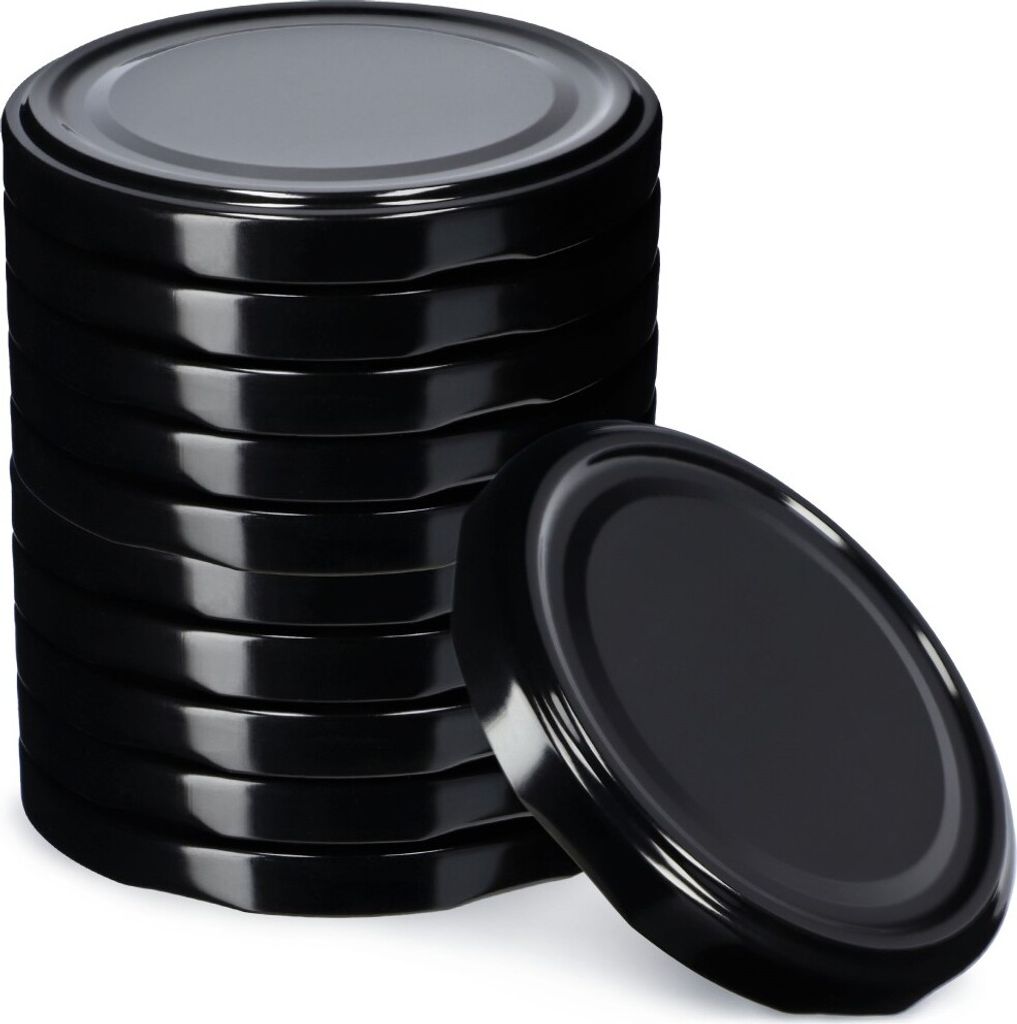 A stack of black metal jar lids with one lid placed in front of the stack.
