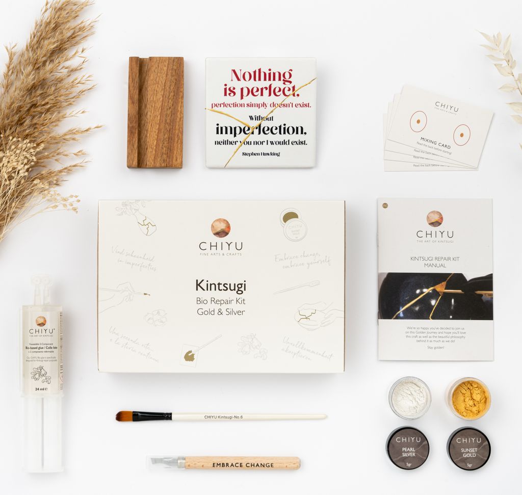 A flat lay of a Kintsugi repair kit and related items.
