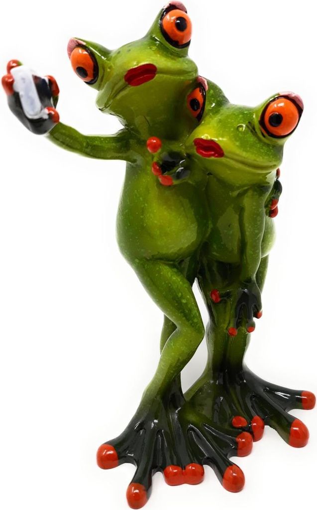 A figurine of two green frogs taking a selfie.
