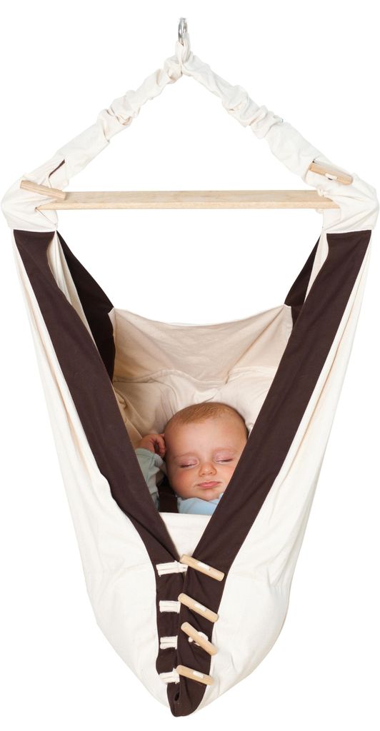 A baby sleeping in a hanging hammock.