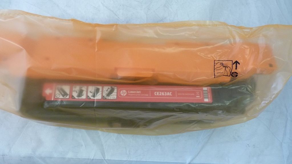 A toner cartridge inside its packaging.