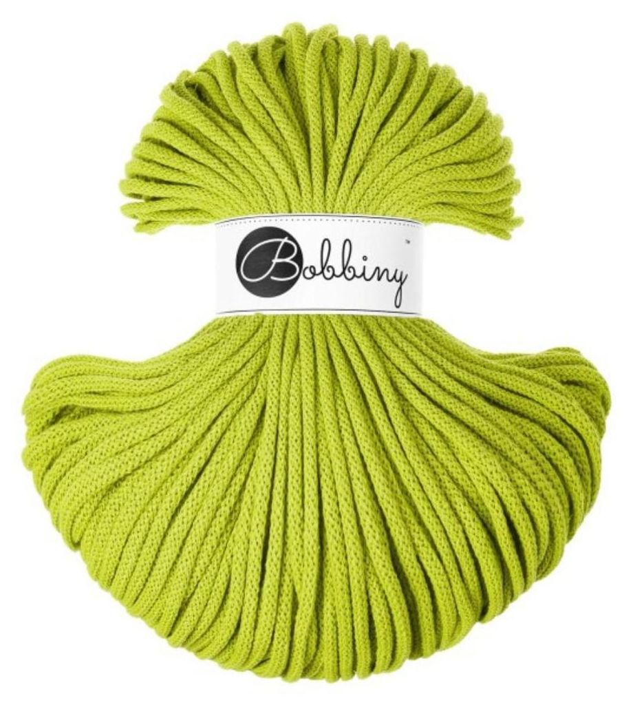 A spool of green yarn on a white background.