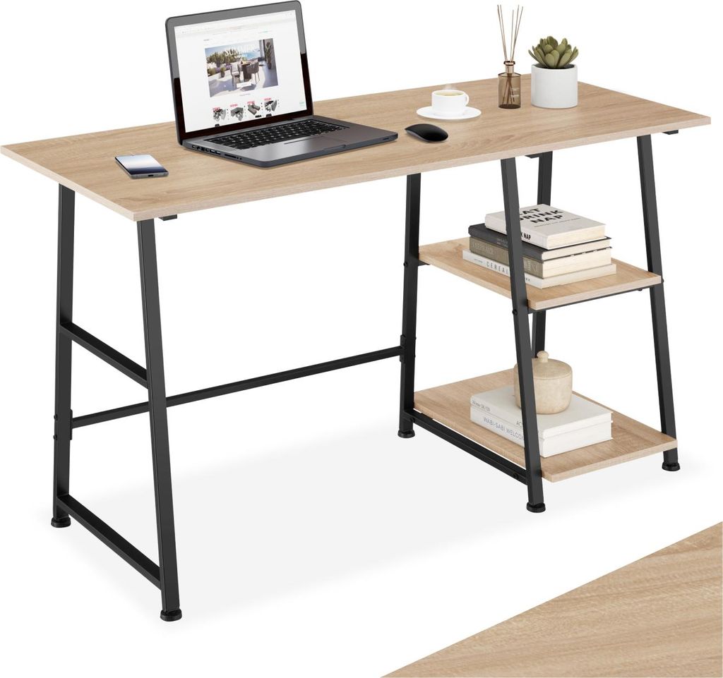 A desk with a laptop, mouse, phone, and books on shelves.
