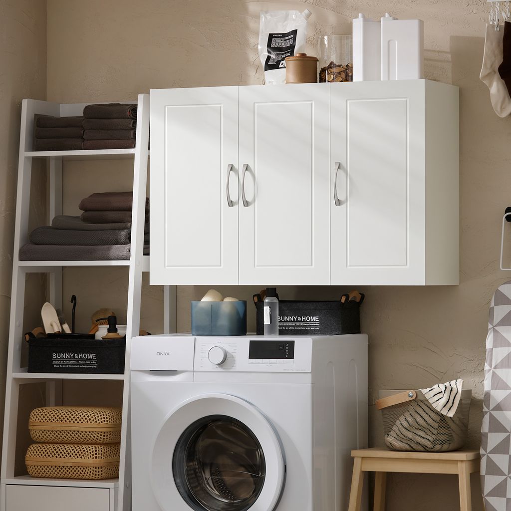 A laundry room scene with a washing machine, wall cabinet, and shelving unit.