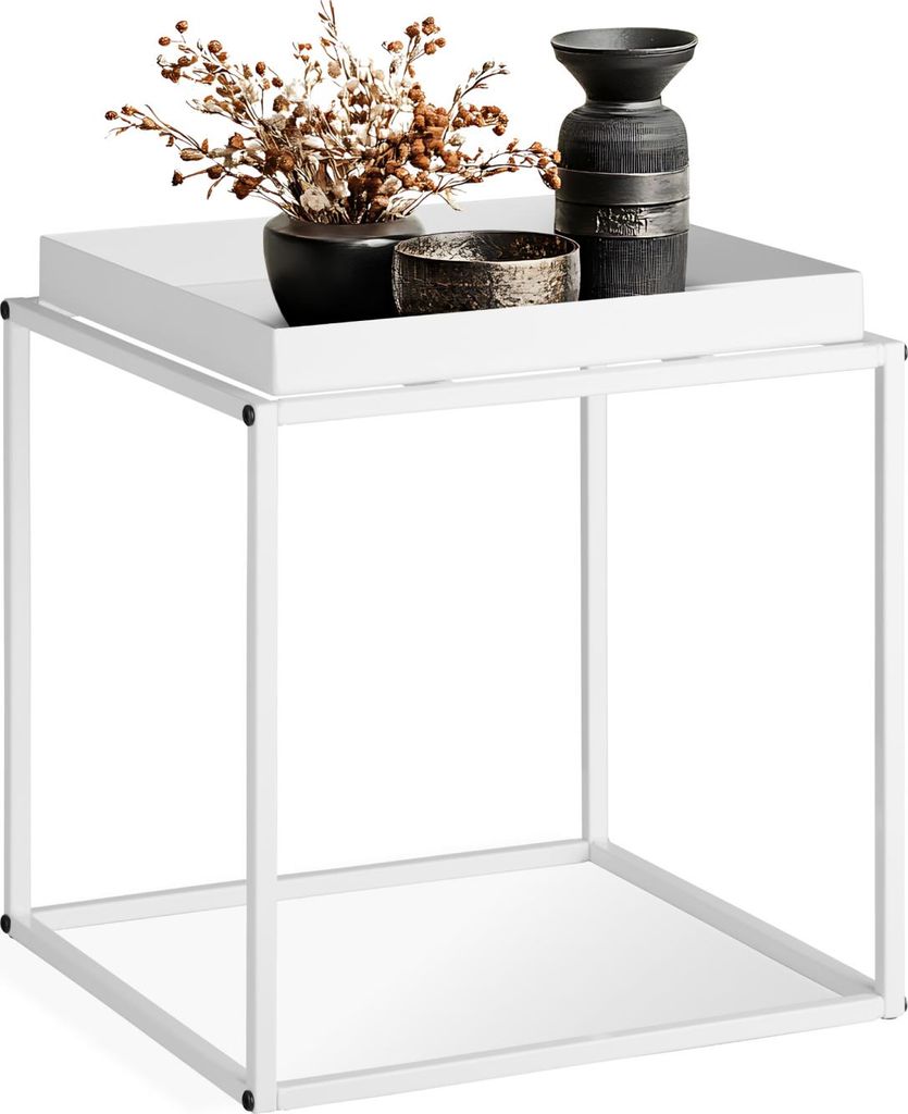 A white metal side table with decorative items on top.