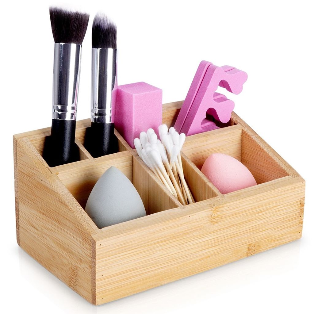 A bamboo organizer filled with makeup accessories.
