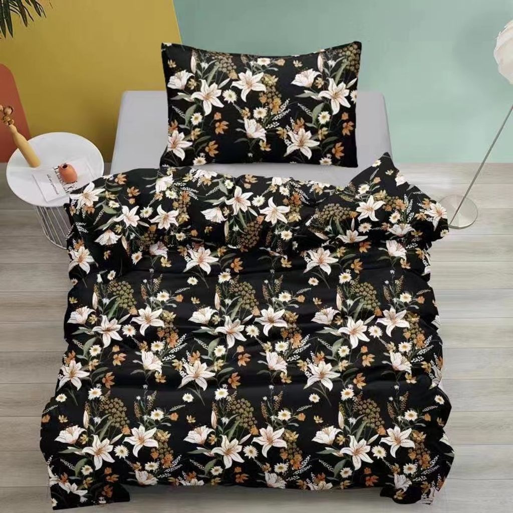 A floral patterned duvet cover and pillow on a bed.