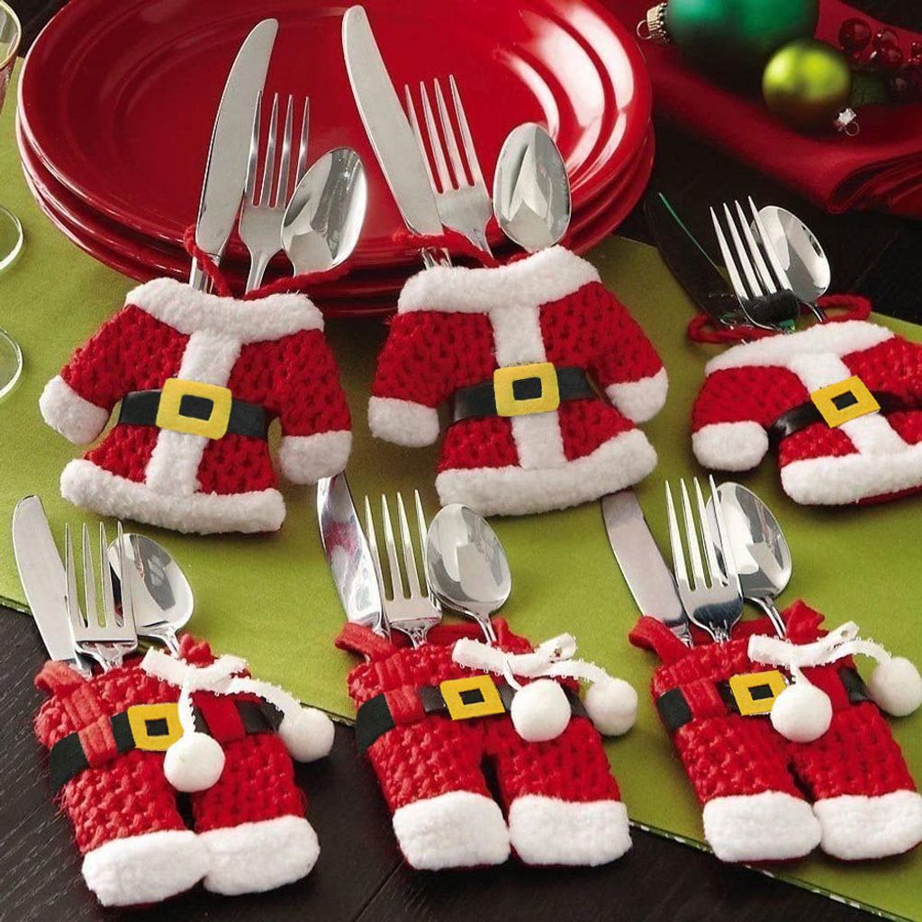 Christmas table setting with Santa-themed cutlery holders.