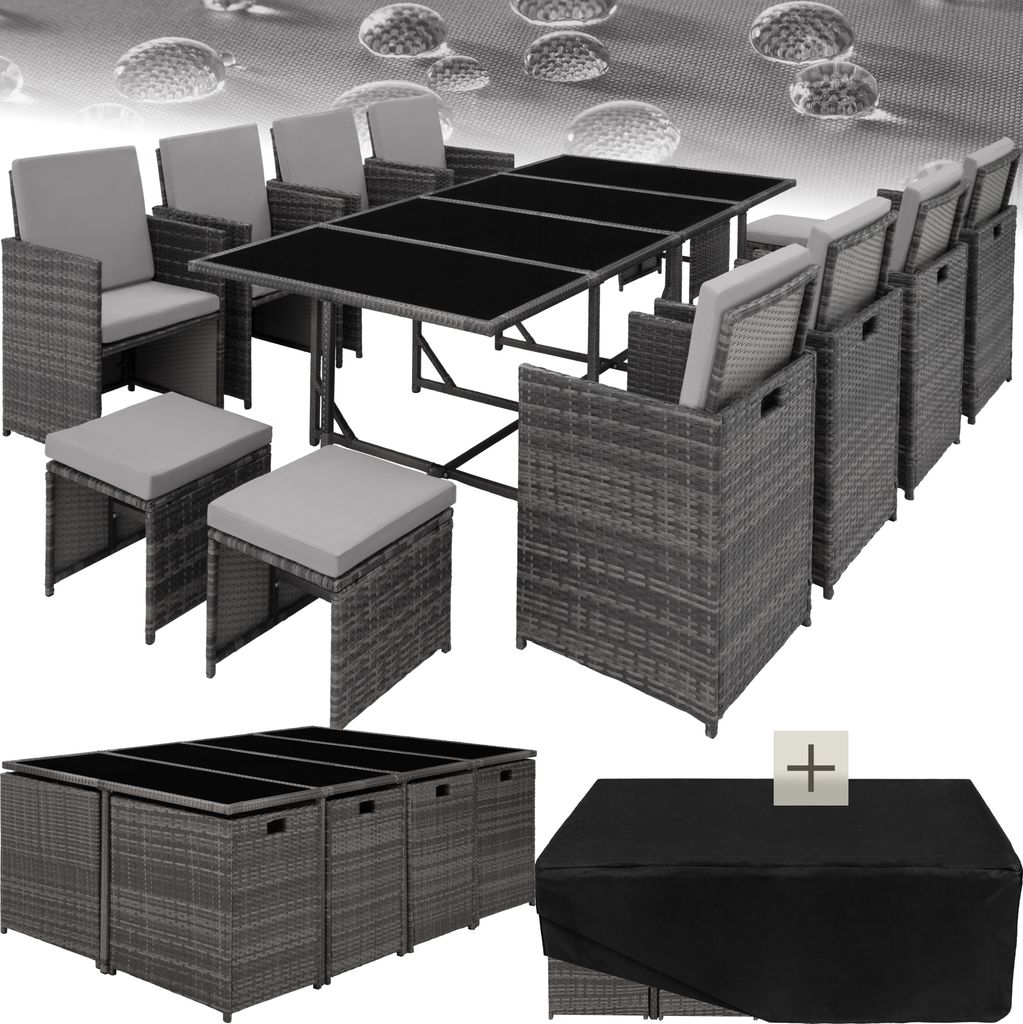 A rattan garden furniture set with a table and chairs, along with a cover.