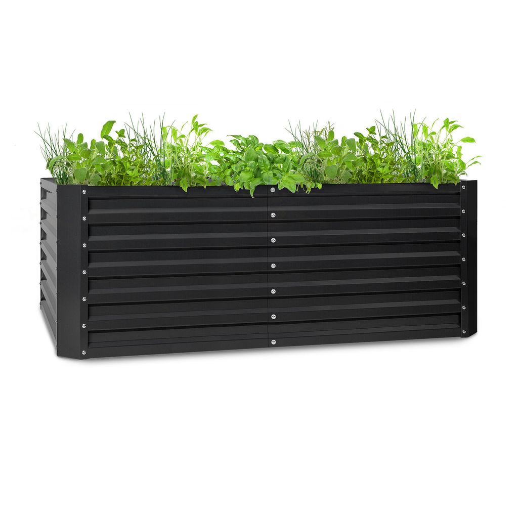 A black metal raised garden bed filled with green plants.