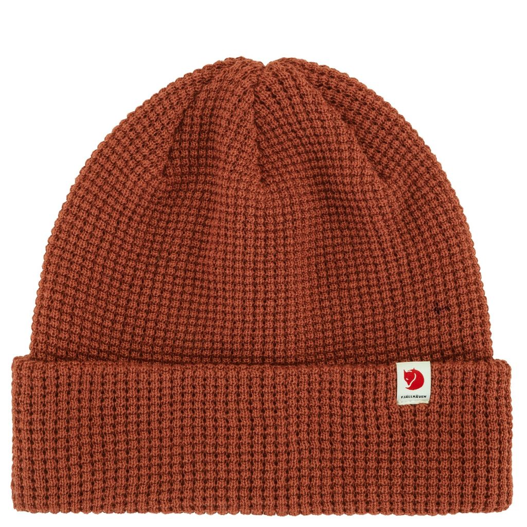 A close-up studio shot of a brown knitted beanie.