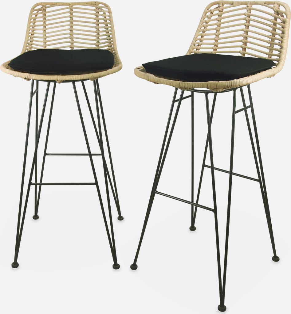 Two bar stools with rattan backs and black cushions on metal legs.