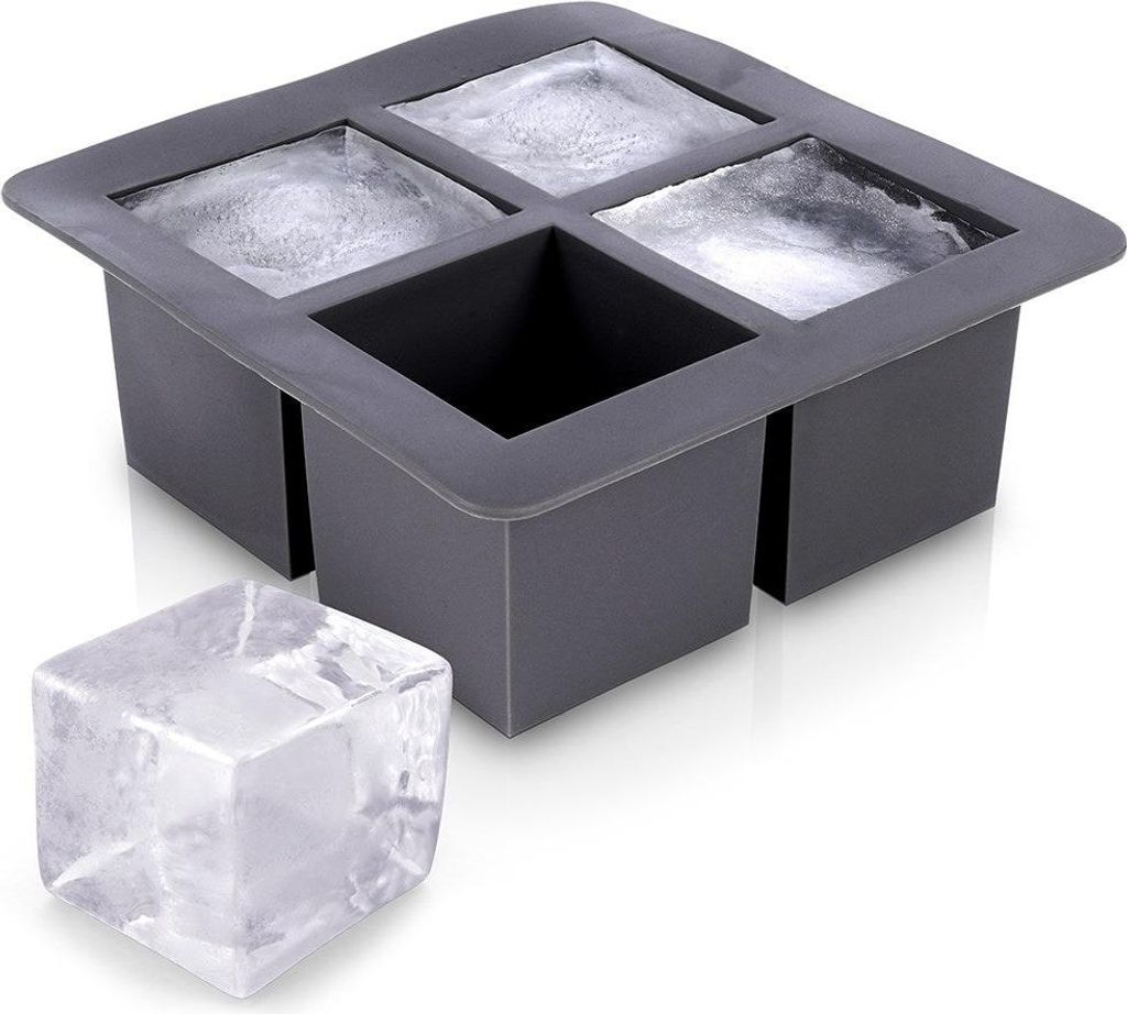 A gray silicone ice cube tray with four large square molds, two of which contain ice. A single large ice cube sits in front of the tray.